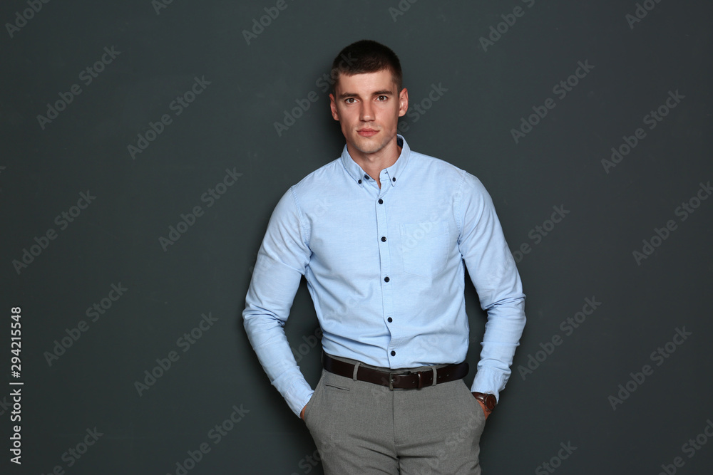 Portrait of handsome young man on dark background