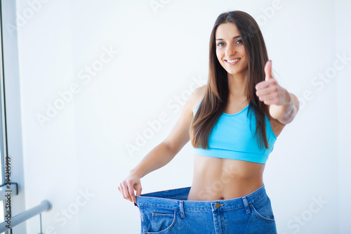 Diet. Beautiful Sporty Woman Showing How Much Weight She Lost