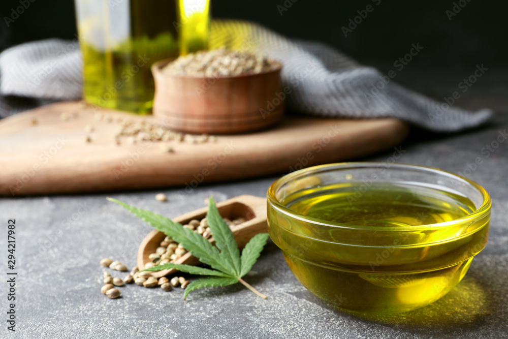 Composition with hemp oil on grey stone table Composition with hemp oil on grey stone table