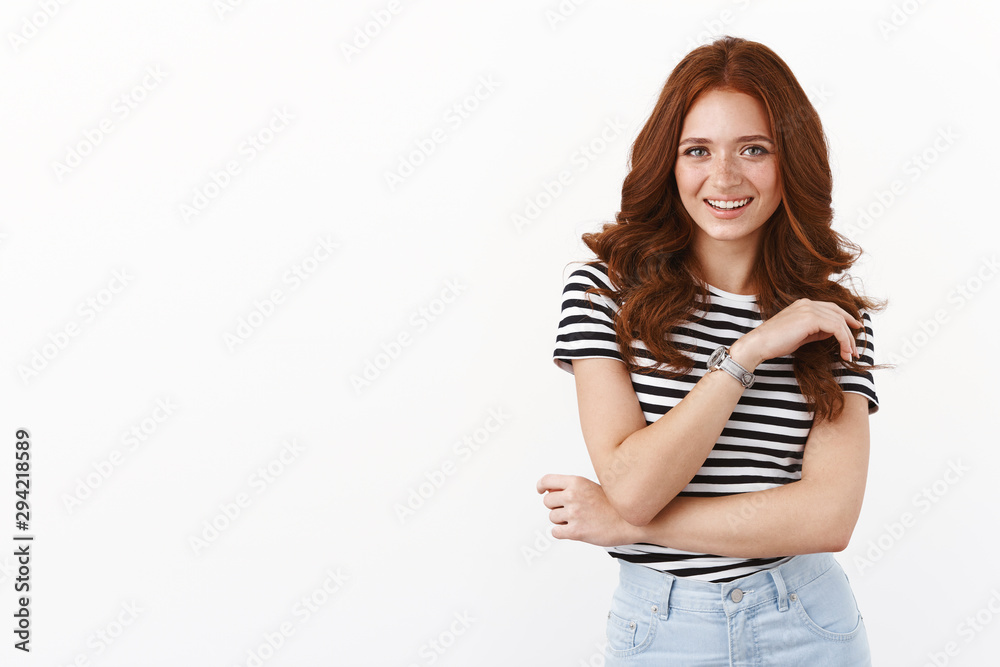 Attractive happy redhead girl with freckles in striped t-shirt, cross arm modest, laughing joyfully, having funny conversation, smiling adoration and joy, standing white background