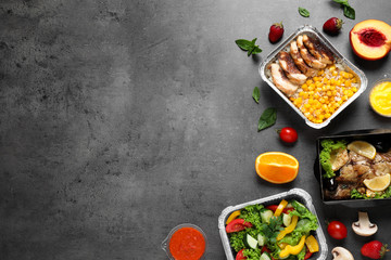 Lunchboxes on grey table, flat lay. Healthy food delivery