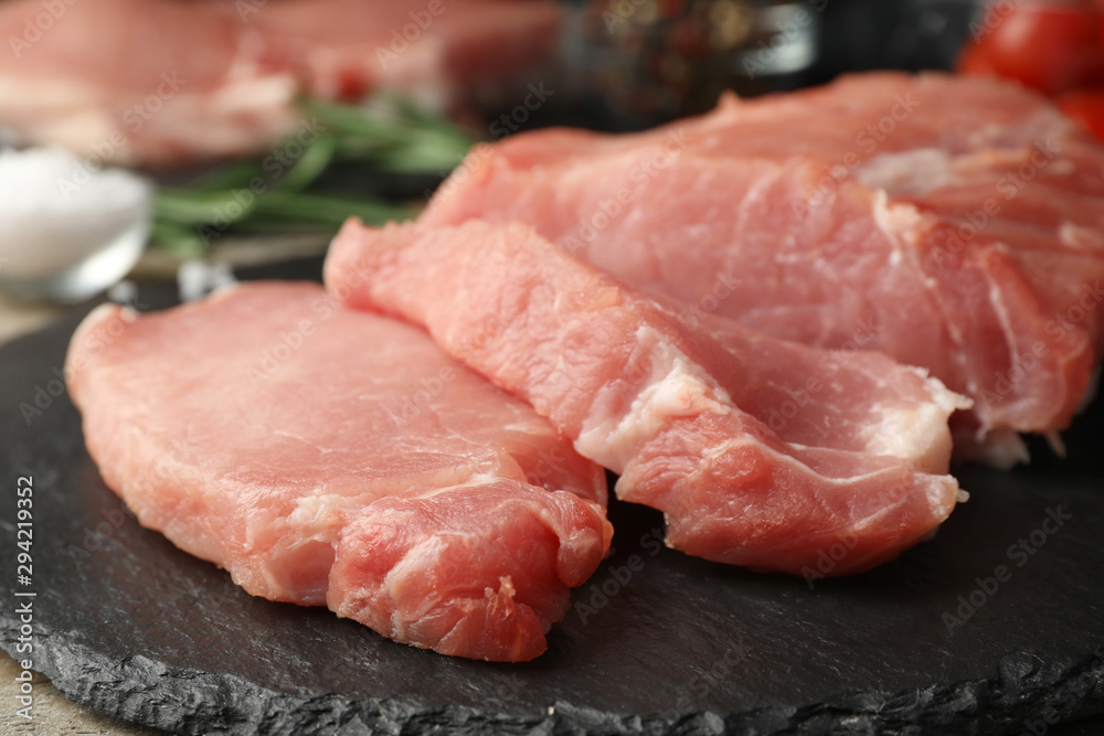 Fresh raw cut meat on slate plate, closeup