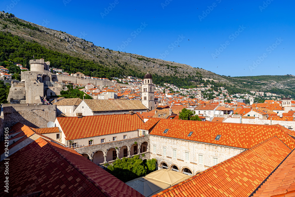 A view to the city walls of Dubrovnik and of St. Saviour Church on daylight