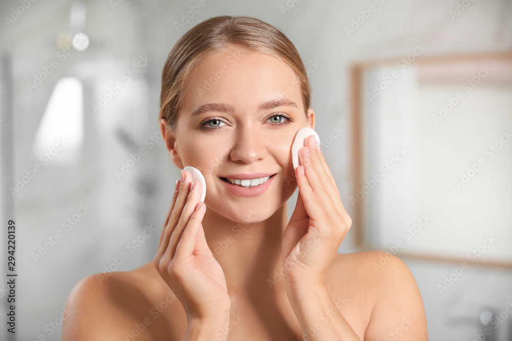 Beautiful young woman with cotton pads indoors Beautiful young woman with cotton pads indoors