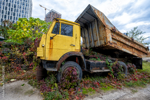 old rusty truck standing in green grass and vegetation © savantermedia