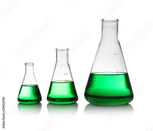 Conical flasks with green liquid on white background