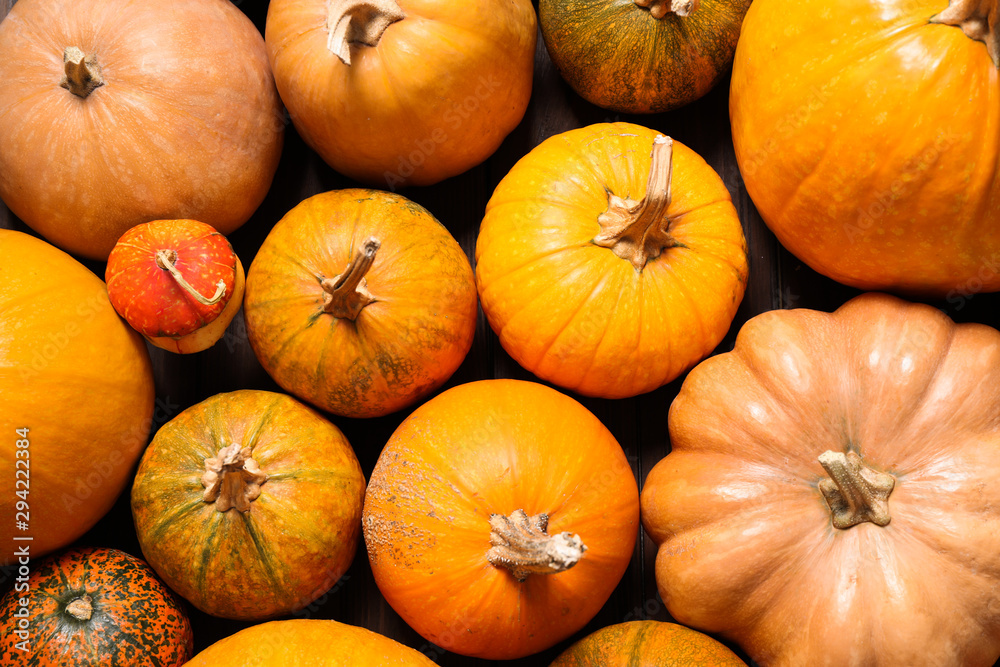Many fresh raw whole pumpkins as background, top view. Holiday decoration Many fresh raw whole pumpkins as background, top view. Holiday decoration