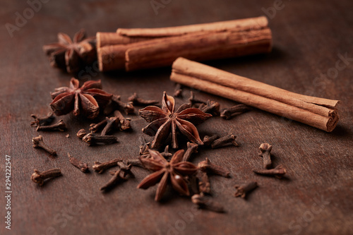 Star anise, cinnamon and dry spice cloves. Christmas spices on rustic wooden background. Close up. 