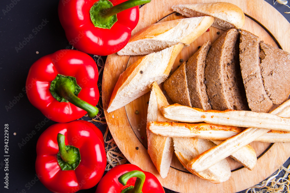 Sliced slices of black fresh rye bread on a round plate Sliced slices of black fresh rye bread on a round plate