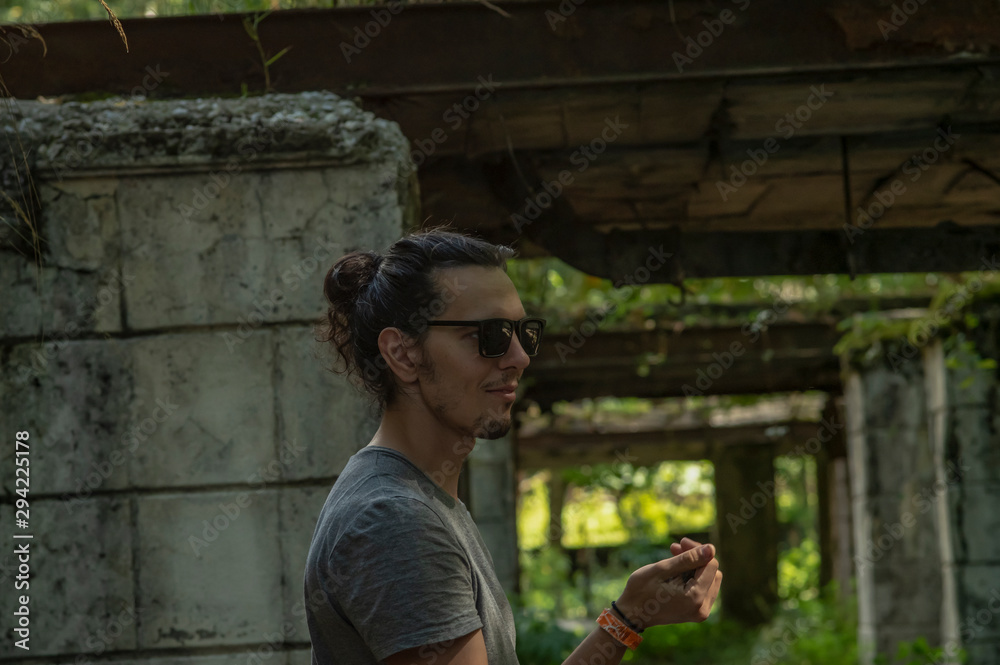 A cheerful man of European appearance walks through the ruins. Historical sights. Travel, travel concept A cheerful man of European appearance walks through the ruins. Historical sights. Travel, travel concept