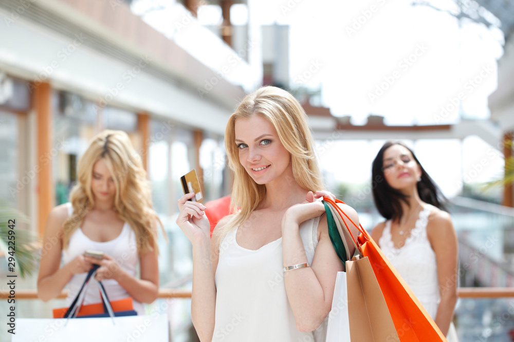Woman shopping with golden credit card Woman shopping with golden credit card