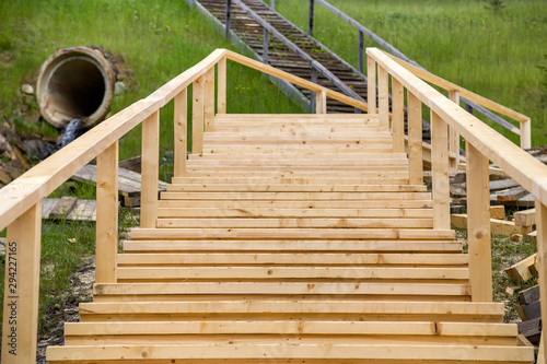 Fototapeta Naklejka Na Ścianę i Meble -  New wooden stairs outdoors. Carpenters work.
