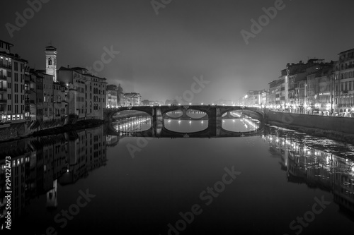 Night view of the Arno river from the famous Ponte Vecchio. Florence, Tuscany, Italy