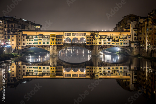 Night view of the Arno river and the famous Ponte Vecchio. Florence, Tuscany, Italy photo