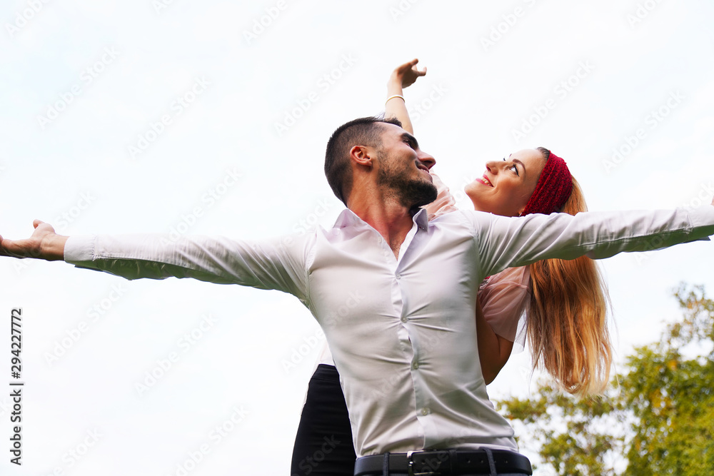 trait of excited funny funky two people look at sky space hold hand near eyes hug piggyback wear stylish trendy clothes. Happy couple piggybacking. 