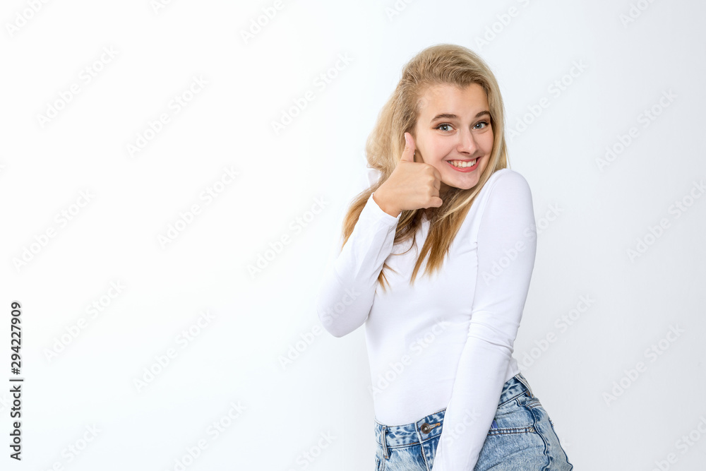 oung blonde woman in a white top and trendy jeans posing on a white background oung blonde woman in a white top and trendy jeans posing on a white background