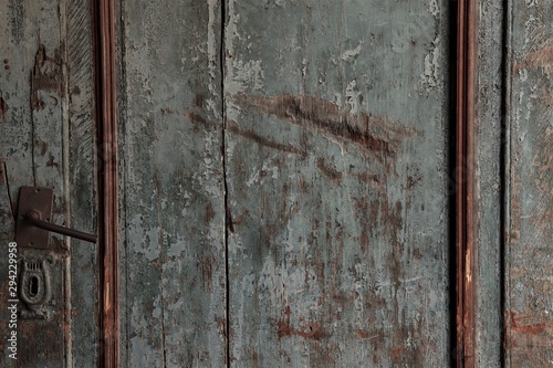 old door with keyhole and iron handle