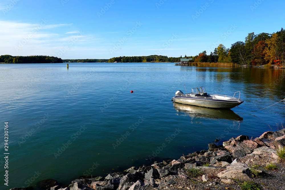 Fototapeta Ruissalo island, turku, Finland. Beautiful seascape with calm sea and moored motor boat on autumn.
