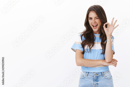 Assured ambitious lovely female entrepreneur self-assured looking confident, wink and smiling motivated show okay ok, no problem sign, give positive feedback, like idea, judging cool product photo