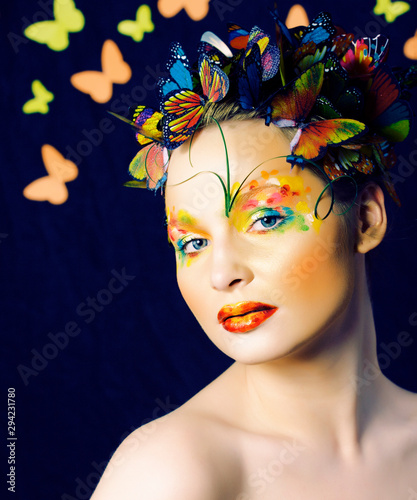 woman with summer creative make up like fairy butterfly closeup bright colored background