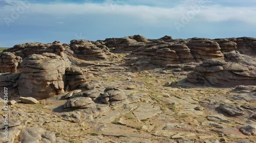 Aerial view on rock formations and stacked stones on granite hilltops, Baga Gazriin Chuluu, Gobi desert, Mongolia, 4k photo