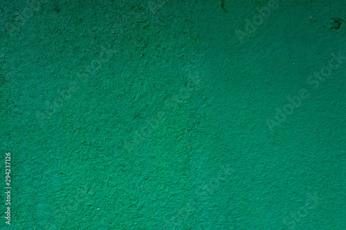 Green painted wooden surface with a rough texture