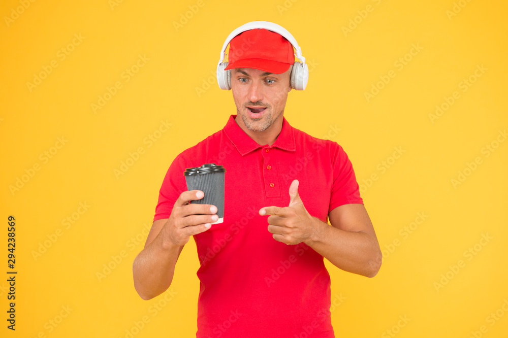 Cafe stuff red uniform with cap serving coffee yellow background. Man recommend to try drink. Hot beverage. Here is your coffee. Cafe operator cashier hold coffee cup. Have a nice day. Coffee to go Cafe stuff red uniform with cap serving coffee yellow background. Man recommend to try drink. Hot beverage. Here is your coffee. Cafe operator cashier hold coffee cup. Have a nice day. Coffee to go