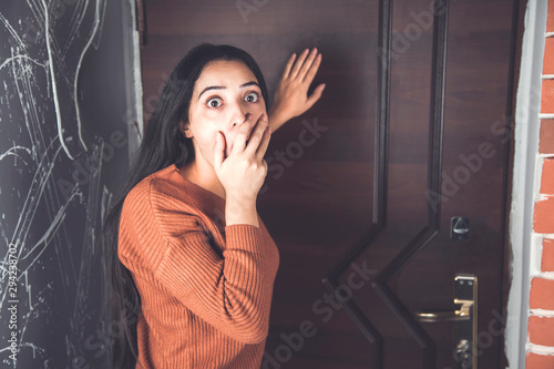 Foto the frightened woman behind the door