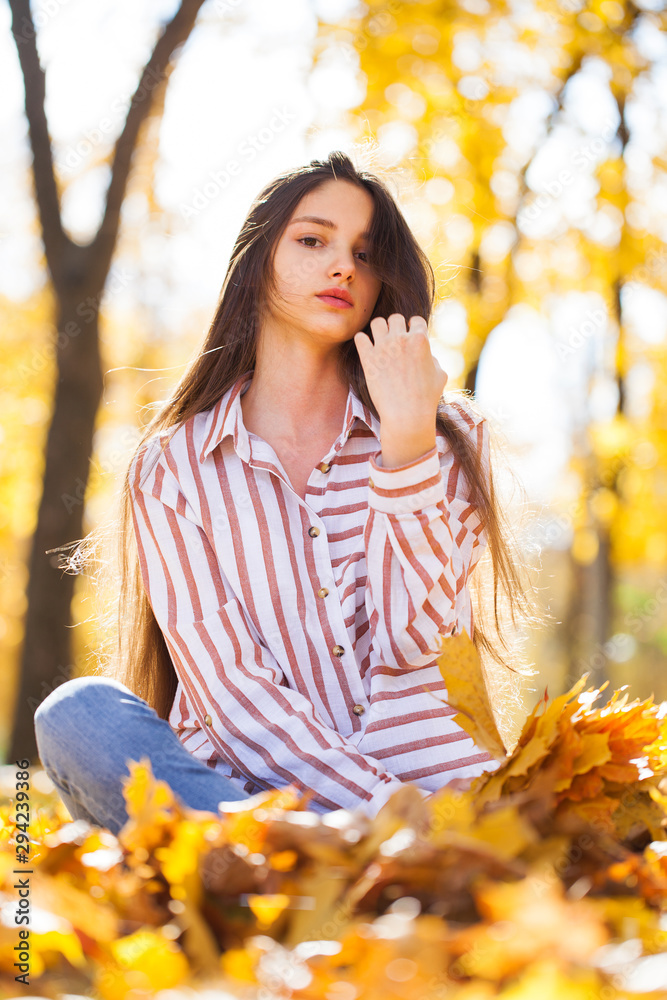 Portrait of a young beautiful girl with yellow maple leaves Portrait of a young beautiful girl with yellow maple leaves