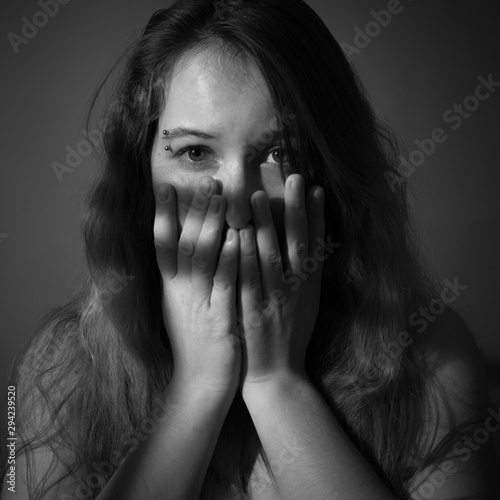 Portrait of scared young woman. Black and white.