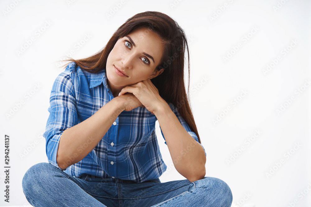 Close-up attractive romantic tender middle-aged wife with tattoos looking camera thoughtful, passionate, tilt head lean hands sit on crossed legs over white background, daydreaming, thinking Close-up attractive romantic tender middle-aged wife with tattoos looking camera thoughtful, passionate, tilt head lean hands sit on crossed legs over white background, daydreaming, thinking
