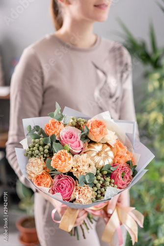 Beautiful bouquet of mixed flowers in womans hands. the work of the florist at a flower shop. Fresh cut flower.