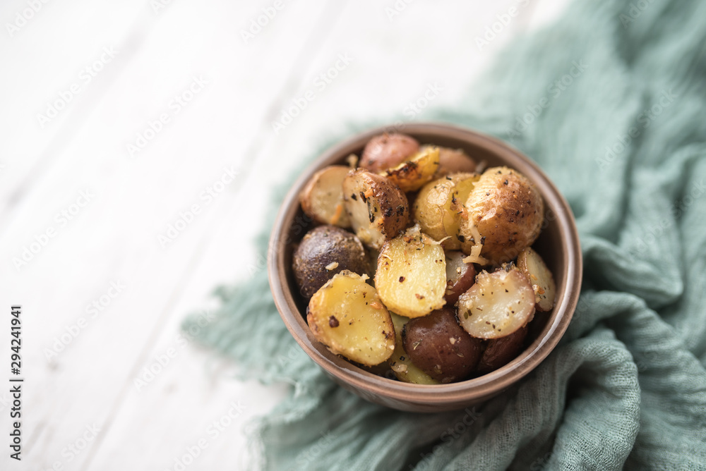 Delicious Roasted mini potato with spices and Parmesan cheese, cut in halves Delicious Roasted mini potato with spices and Parmesan cheese, cut in halves