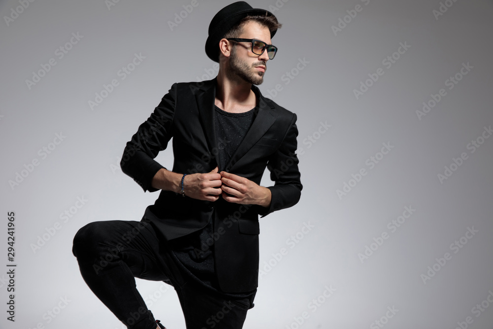 casual man standing and fixing jacket confident casual man standing and fixing jacket confident