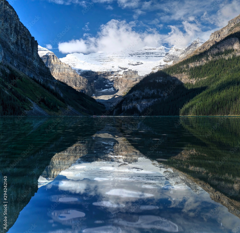 Lake Louise reflections in the morning.  Beautiful reflections of mountains and glacier over the lake in a calm water of alpine lake. Banff National Park.  Alberta. Canada