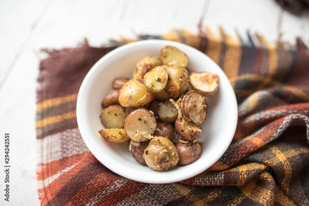 Delicious Roasted mini potato with spices and Parmesan cheese, cut in halves Delicious Roasted mini potato with spices and Parmesan cheese, cut in halves