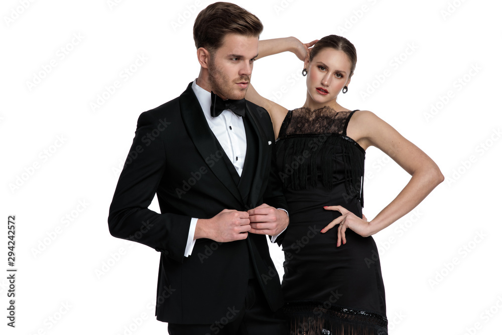 Young couple posing while she is leaning on him Young couple posing while she is leaning on him