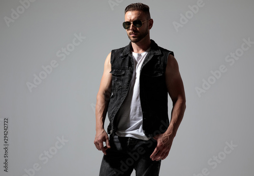 Serious looking man wearing sunglasses and jeans vest © Viorel Sima