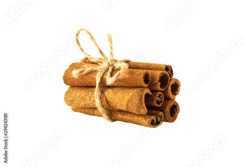 Side view of bunch of cinnamon sticks tied with rope and isolated on white