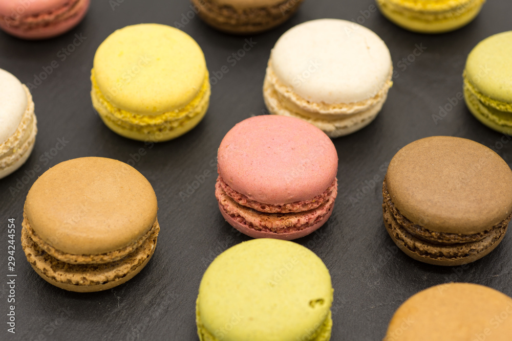 Delicious assorted macarons arranged on a slate Delicious assorted macarons arranged on a slate