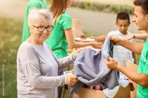 Young volunteer giving new ...