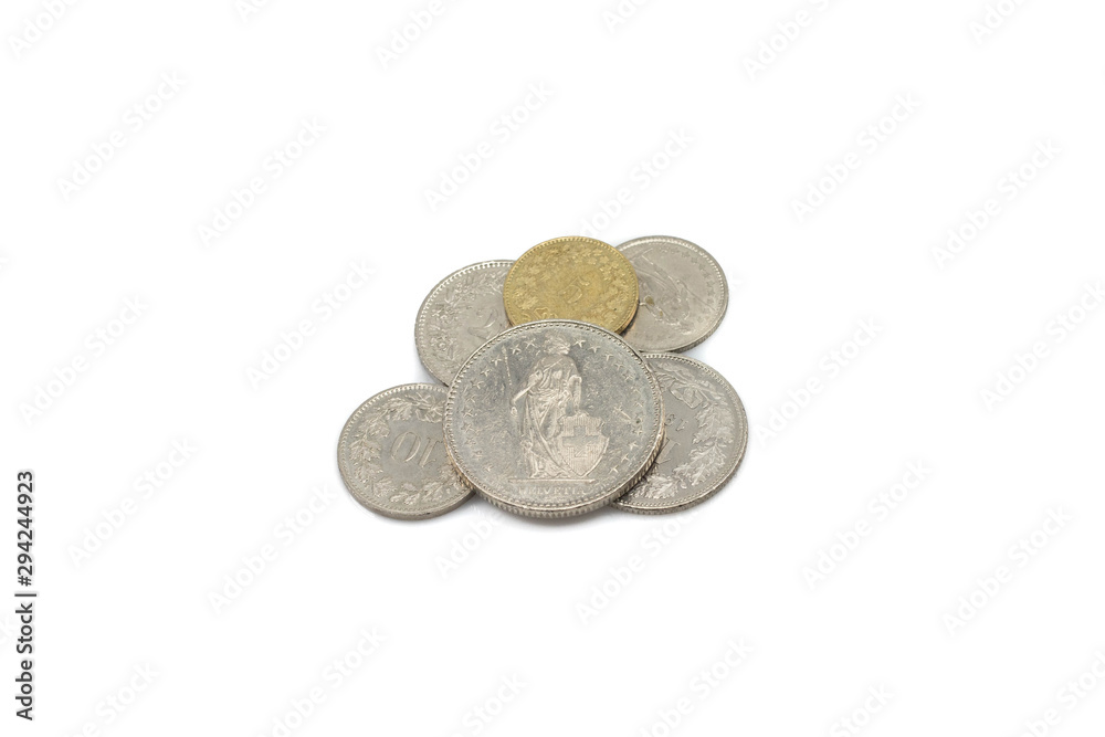 A close up image of a pile of silver and gold Swiss franc coins isolated on a clean, white background. Shot in macro. A close up image of a pile of silver and gold Swiss franc coins isolated on a clean, white background. Shot in macro.