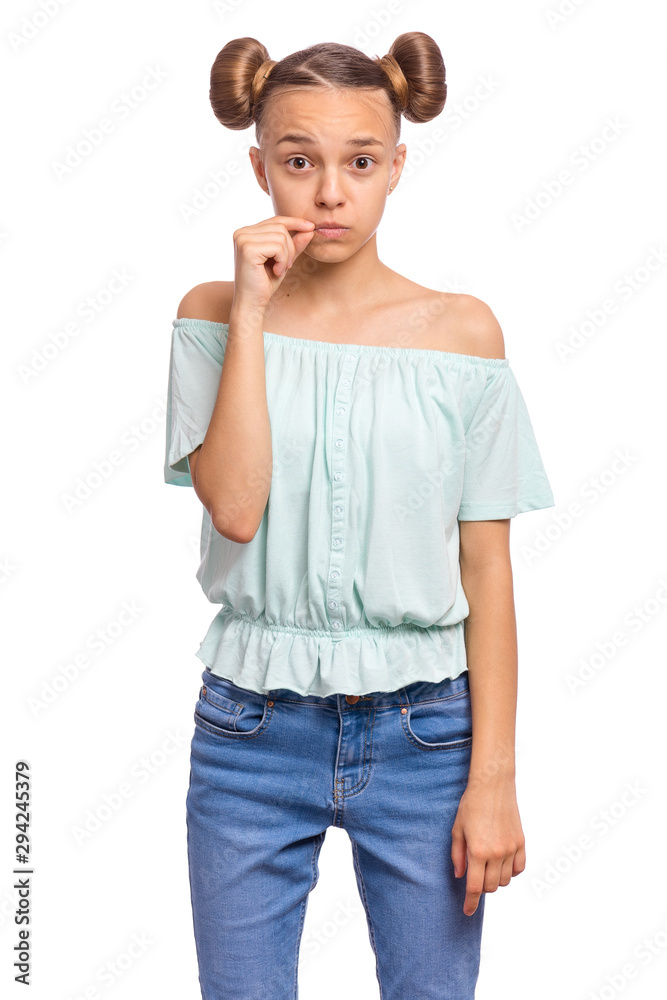 Portrait of teen girl showing sign of closing mouth and silence gesture. My lips are sealed. Child showing zip gesture as if shutting mouth on key. Funny teenager isolated on white background. Portrait of teen girl showing sign of closing mouth and silence gesture. My lips are sealed. Child showing zip gesture as if shutting mouth on key. Funny teenager isolated on white background.