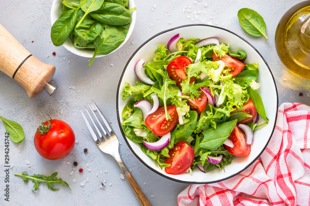 Green salad from fresh leaves and tomatoes.