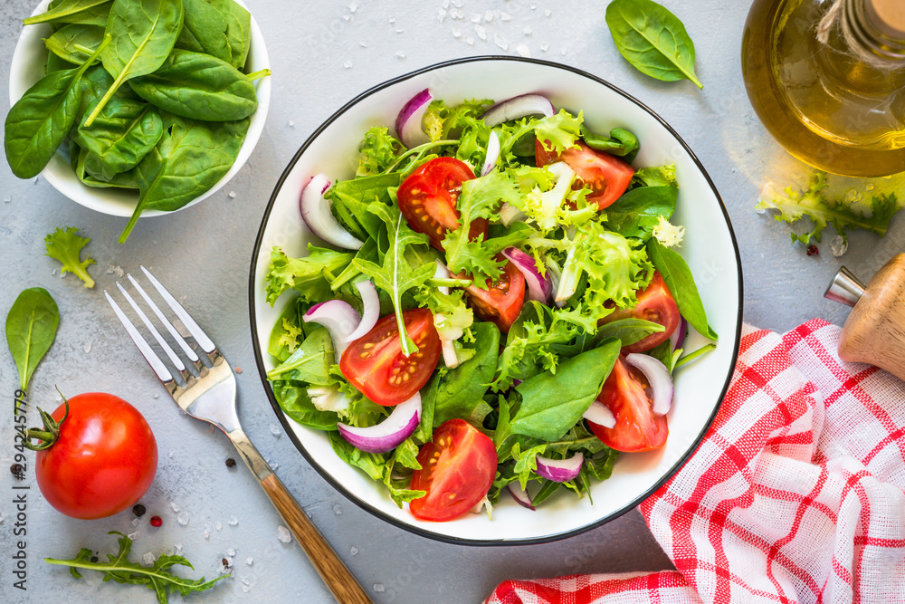 Green salad from fresh leaves and tomatoes.