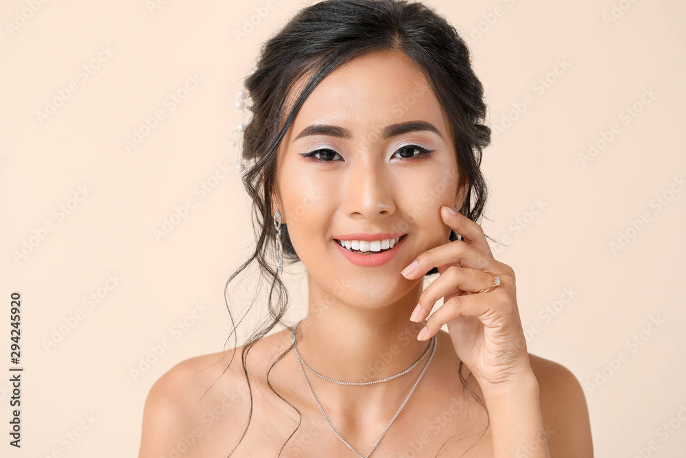 Beautiful young Asian bride on light color background Beautiful young Asian bride on light color background