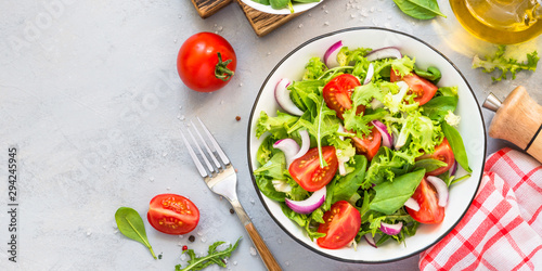 Green salad from fresh leaves and tomatoes.