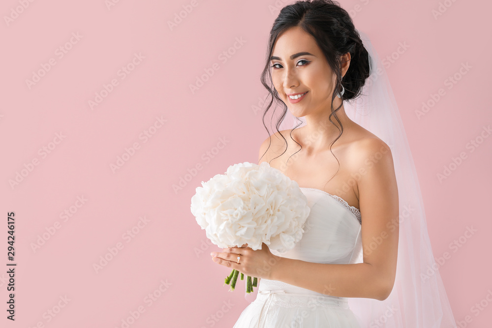 Beautiful young Asian bride on color background Beautiful young Asian bride on color background