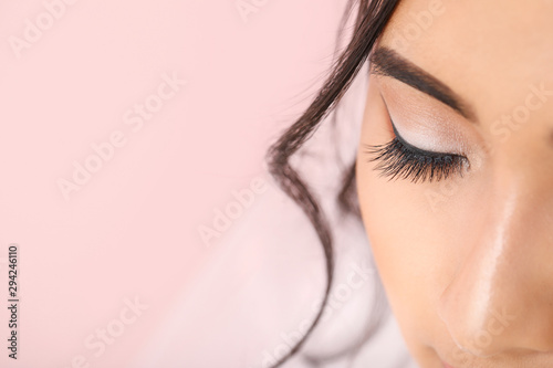 Young Asian bride with beautiful makeup on color background, closeup