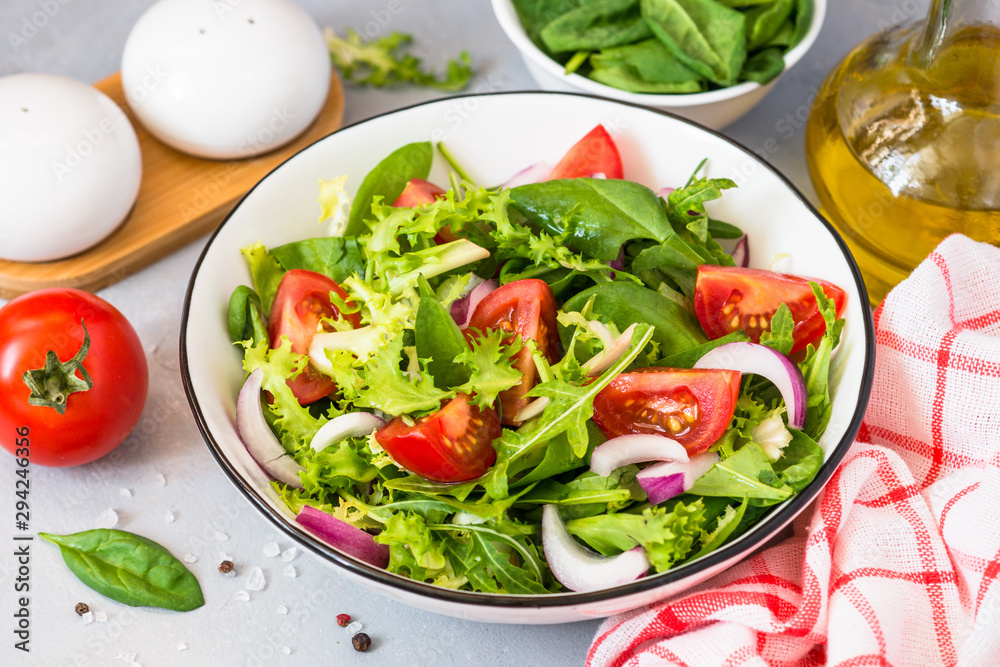 Green salad from fresh leaves and tomatoes.